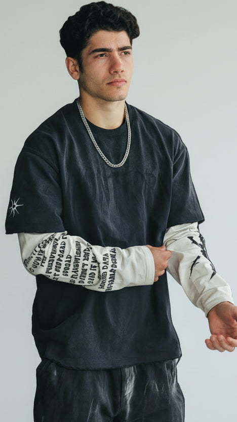 Person lying on a black mat with a neutral background
