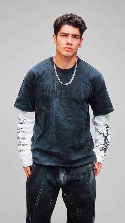 Man wearing a dark gray t-shirt and black pants on a white background