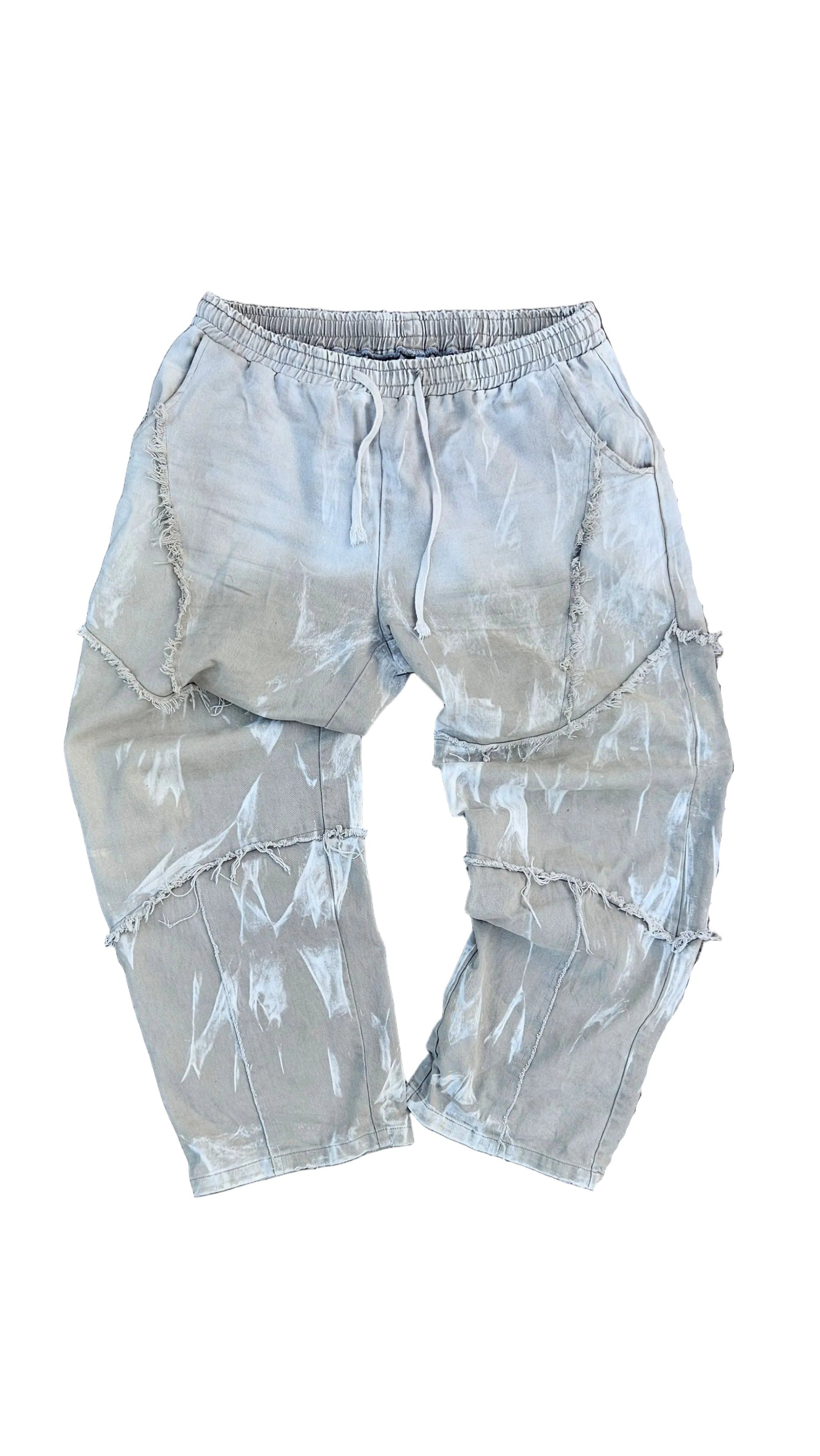 White pants on a gray concrete floor with a person's feet visible