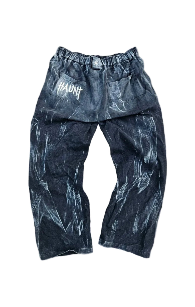 Dark pants with a pattern on a gray concrete surface