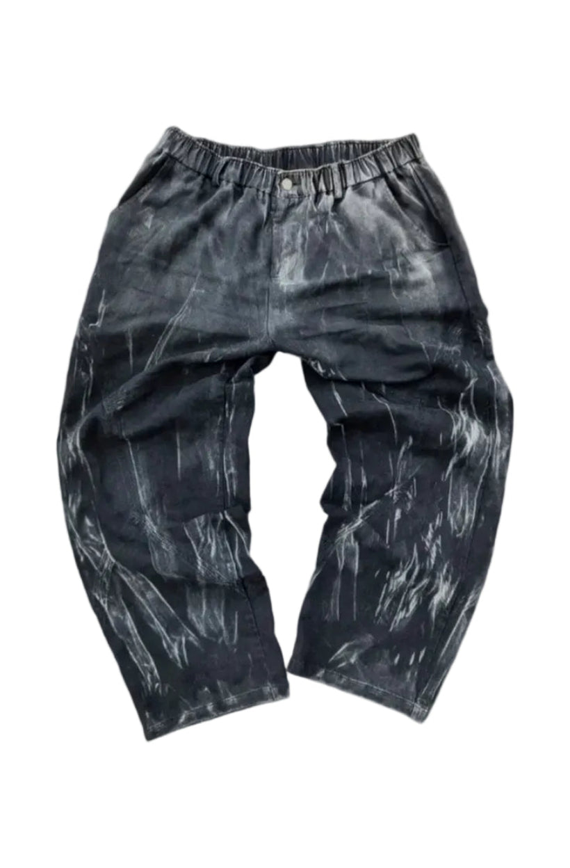 Black pants with a textured pattern on a gray surface